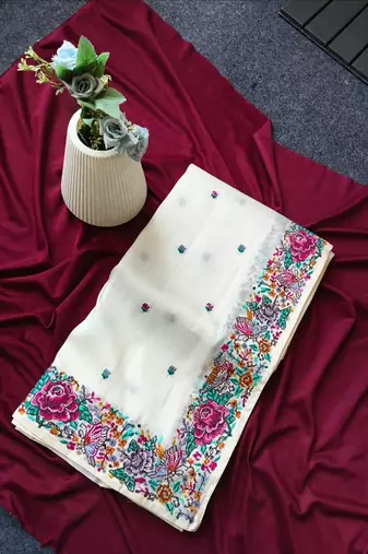 White tissue viscose saree features a heavy floral embroidered border and all-over buttis