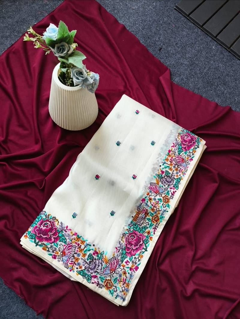 White tissue viscose saree features a heavy floral embroidered border and all-over buttis