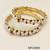 Pearl bangle set with ruby and black stone accents, gold-tone, openable