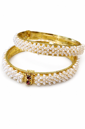 Pearl bangle set with red stone accents, gold-toned, openable, 