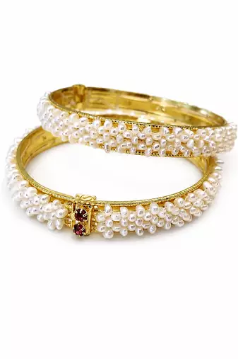 Pearl bangle set with red stone accents, gold-toned, openable, 