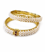 Pearl bangle set with red stone accents, gold-toned, openable, 