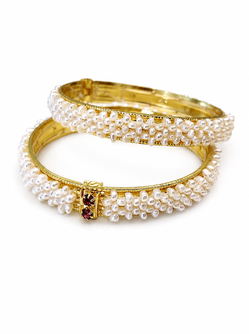 Pearl bangle set with red stone accents, gold-toned, openable, 