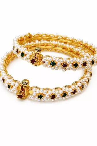 Pearl bangle with red and green stone accents, gold-toned, openable, 