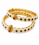 Pearl bangle with red and green stone accents, gold-toned, openable, 