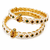 Pearl bangle with red and green stone accents, gold-toned, openable, 