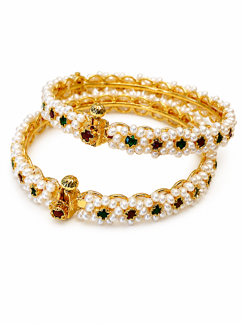 Pearl bangle with red and green stone accents, gold-toned, openable, 