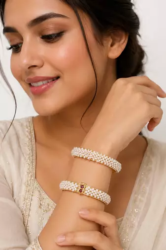 Pearl bangle set with red stone accents, gold-toned, openable, 