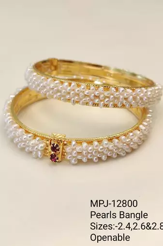 Pearl bangle set with red stone accents, gold-toned, openable, 