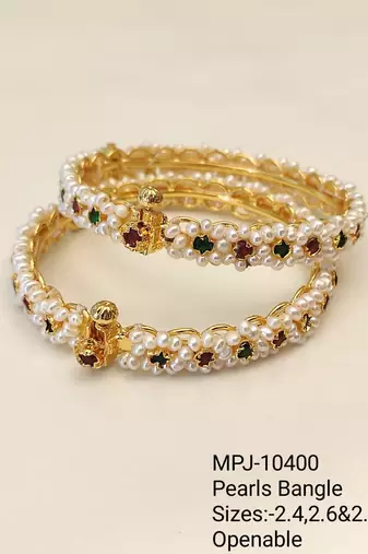 Pearl bangle with red and green stone accents, gold-toned, openable, 