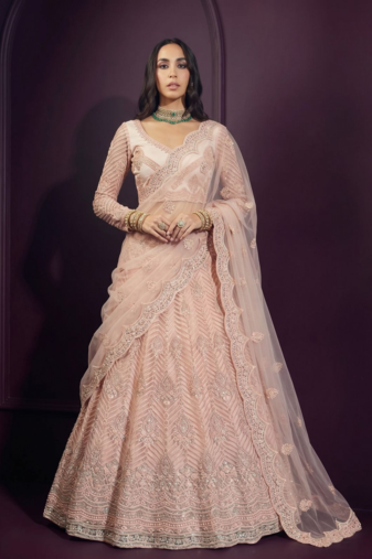 Peach butterfly net fabric with embroidered  resham  sequin   thread work lehengas for your wedding look