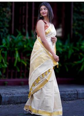 off white zari tissue kasavu saree with golden tassels 2