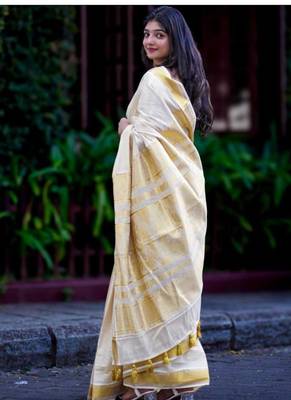 off white zari tissue kasavu saree with golden tassels 3