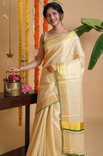 off white zari woven design tissue kasavu saree with green detailing