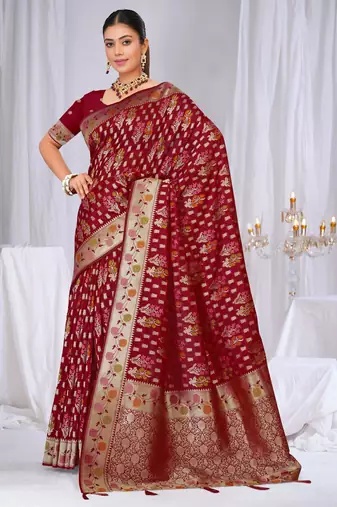 Dusty mauve raw silk saree with zari and floral thread work with tassels