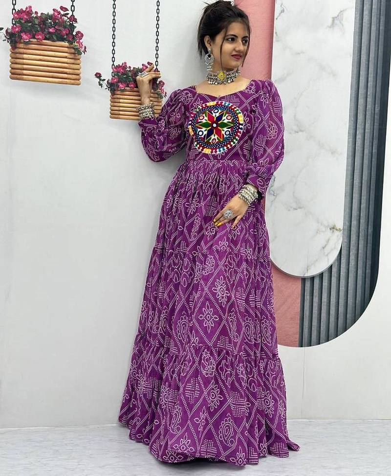 Navratri wear purple color bandhni printed gamathi & mirror work long flared gown full stitched.