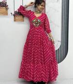 Navratri wear pink color bandhni printed gamathi & mirror work long flared gown full stitched.