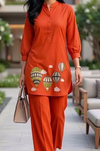Trendy solid orange cotton kurta with hot air balloon embroidery and matching trousers