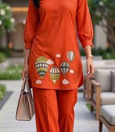  solid orange cotton kurta with hot air balloon embroidery and matching trousers