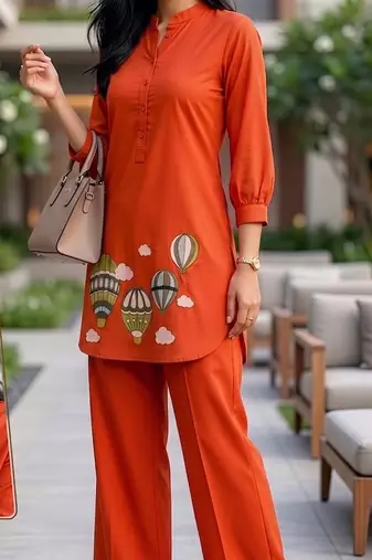 Trendy solid orange cotton kurta with hot air balloon embroidery and matching trousers