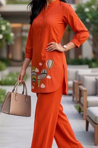 Trendy solid orange cotton kurta with hot air balloon embroidery and matching trousers