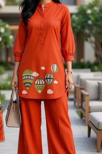 Trendy solid orange cotton kurta with hot air balloon embroidery and matching trousers