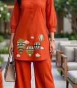 Trendy solid orange cotton kurta with hot air balloon embroidery and matching trousers