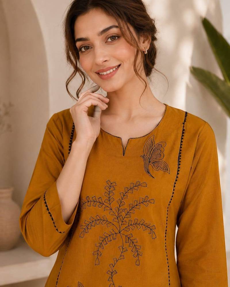 New elegant mustard  cotton kurta with black botanical embroidery and white trousers