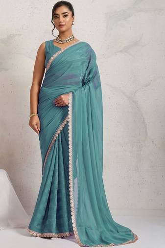 Teal elegant printed georgette saree with blouse piece
