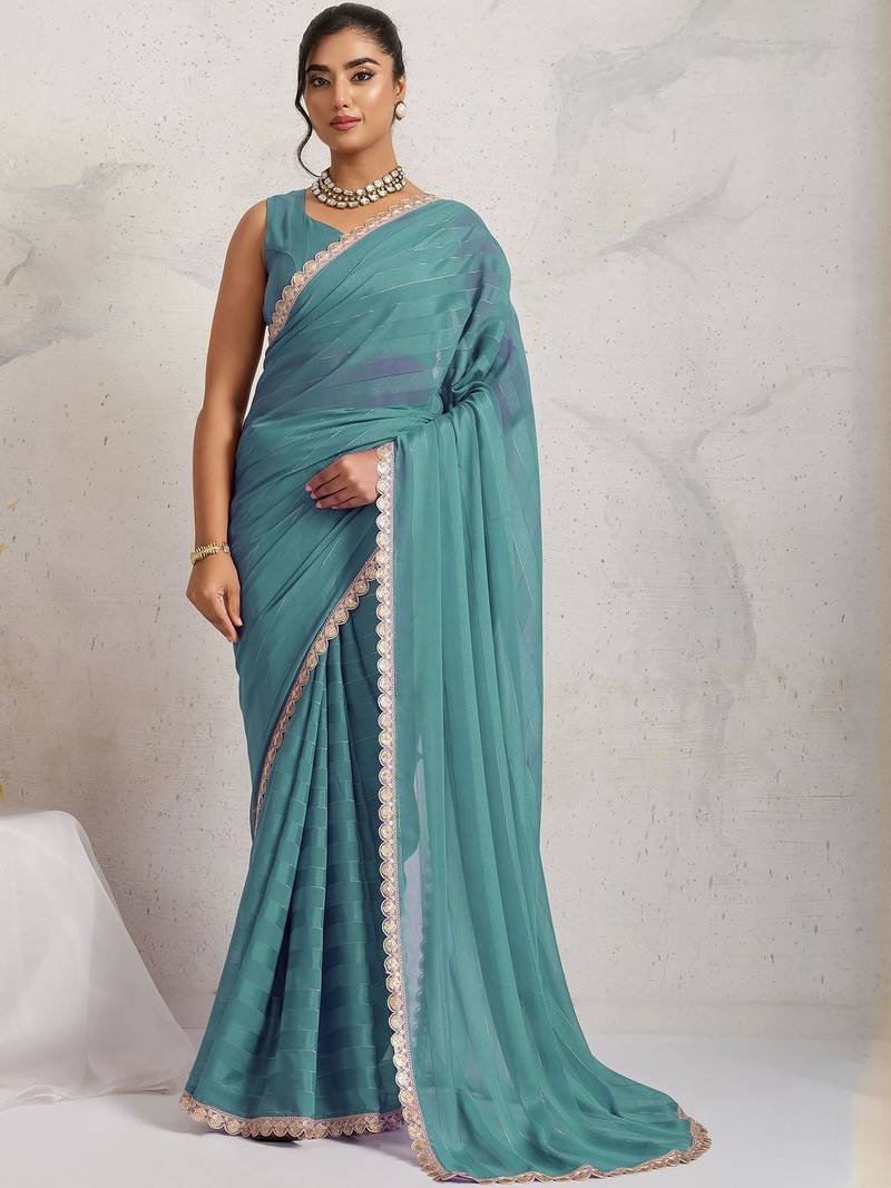 Teal elegant printed georgette saree with blouse piece