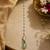 Gold pearl chain mint green jadau stone maang tikka
