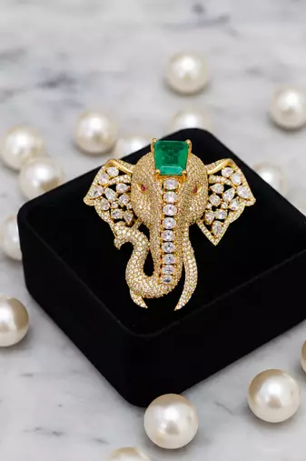 Royal elephant designer brooch with green emerald-cut crystal & american diamond stones | gold-plated statement brooch