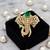 Royal elephant designer brooch with green emerald-cut crystal & american diamond stones | gold-plated statement brooch