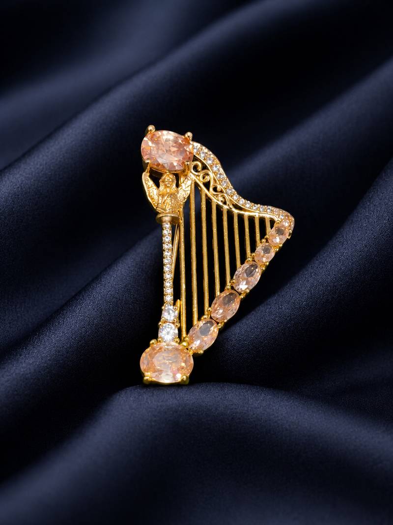 Elegant harp design crystal brooch with peach champagne stones | gold-plated musical instrument brooch pin