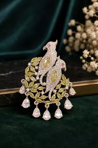 Elegant twin parrot designer brooch with yellow crystal leaves & dangling teardrop stones | brooch