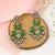 Silver plated green stone kundan dangler earrings