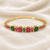 Gold-plated floral kada bracelet with ruby & emerald stones openable free size 