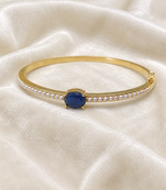 Gold-toned kada bangle with blue oval stone and pearl accents openable free size 