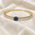 Gold-toned kada bangle with blue oval stone and pearl accents openable free size 