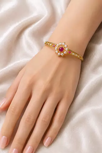 Gold-plated floral bangle with ruby and pearl stones openable free size 
