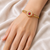 Gold-plated floral bangle with ruby and pearl stones openable free size 