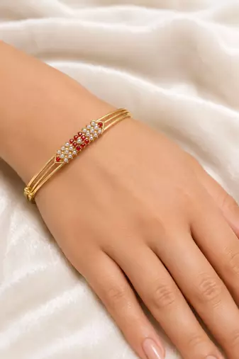 Gold-plated kada bangle with ruby and pearl embellishment openable free size 