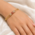 Gold-plated kada bangle with ruby and pearl embellishment openable free size 