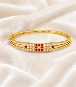 Gold-plated kada bracelet with ruby and pearl embellishments openable free size 