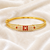 Gold-plated kada bracelet with ruby and pearl embellishments openable free size 
