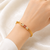 Gold-plated kada bracelet with ruby and pearl embellishments openable free size 