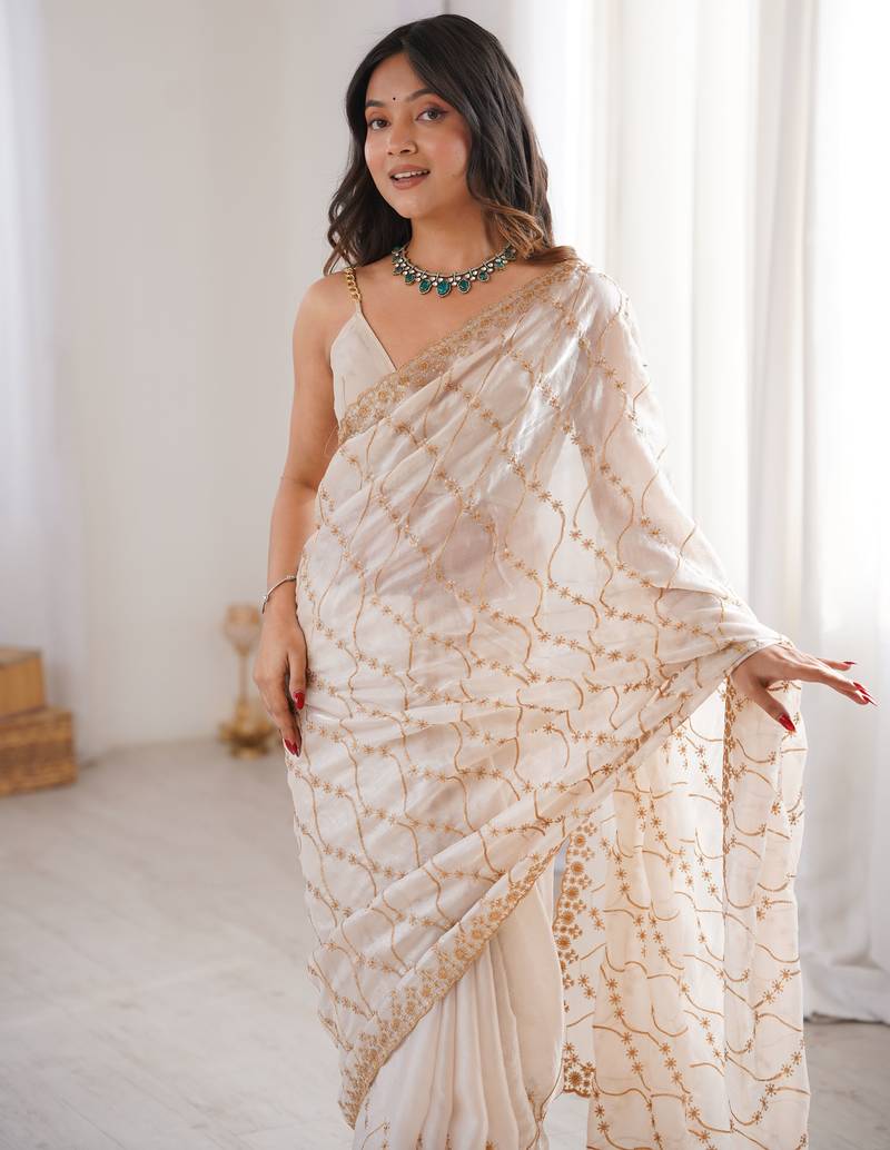 Cream tissue embridered saree with unstitched blouse piece