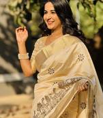 Cream tussar silk embroidered zari woven saree with unstitched blouse piece