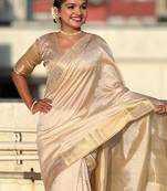 Cream tussar silk zari woven saree with unstitched blouse piece