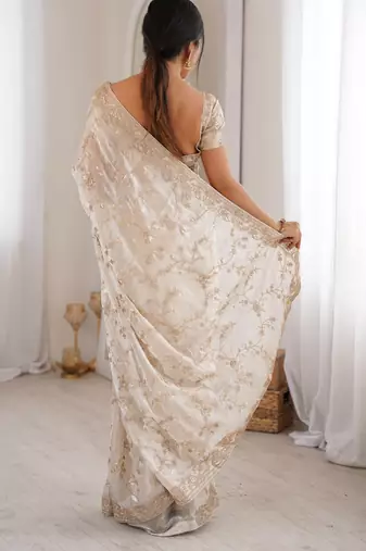 Cream tissue embridered saree with unstitched blouse piece